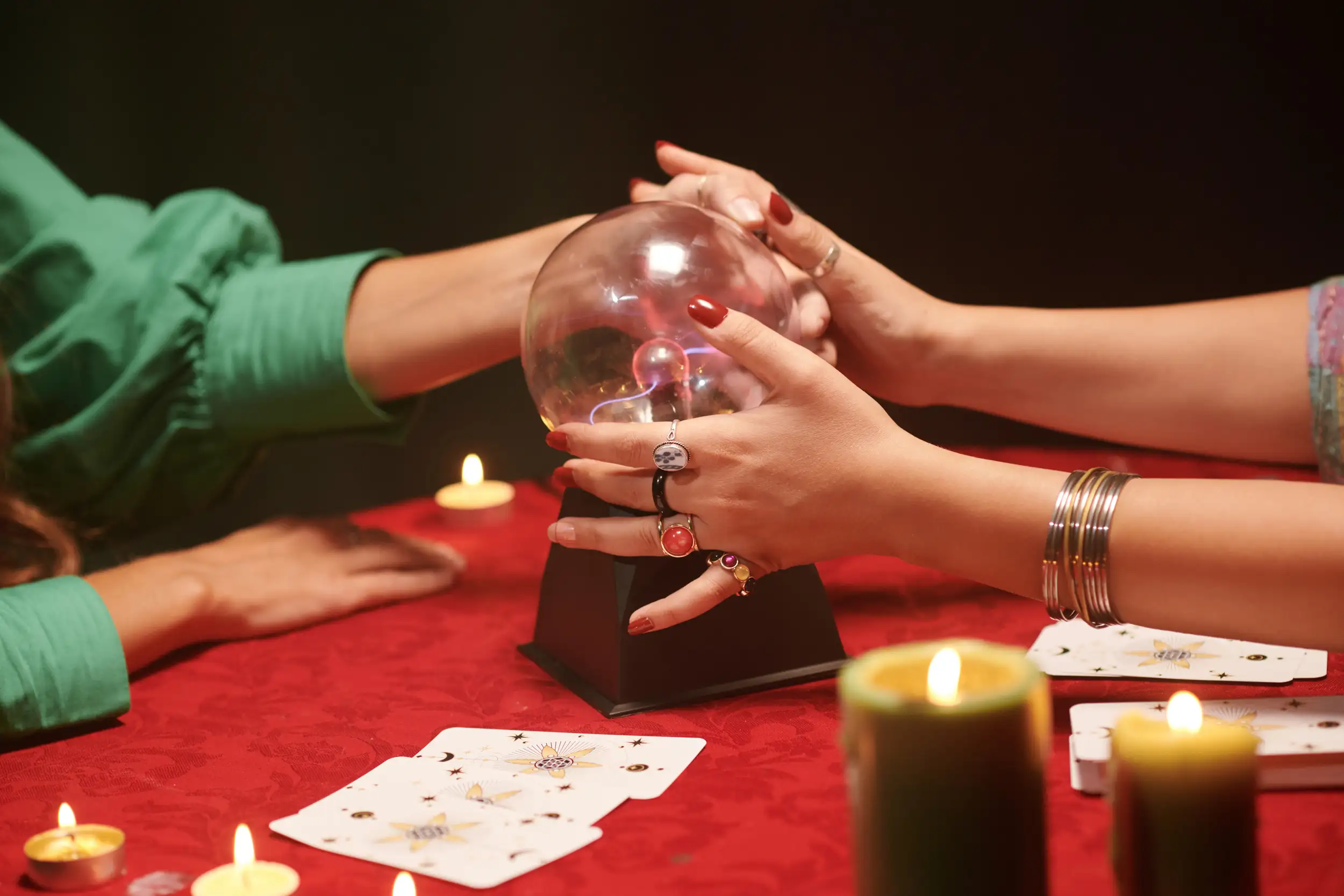 A psychic with a crystal ball reading her client.